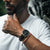 Black leather watch on a hand